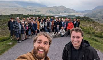 A large group of people with a scenic mountainous background.