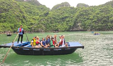 Group of people on a boat in a scenic bay.