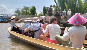 People in a boat under the sun.