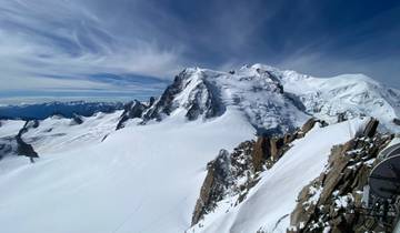 Snow-covered mountain peaks under a clear blue sky.
