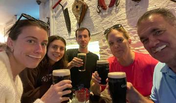 Group of people enjoying drinks in a pub.