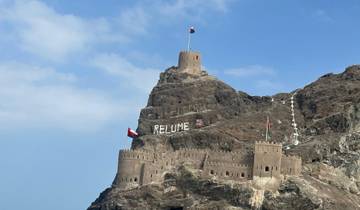 Mountain fortress with flags and 'RELUME' sign.