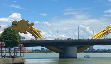 A golden dragon bridge spanning over a river.