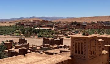 Mudbrick town with desert background and blue sky.