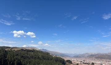 Wide view of a city with mountains and blue sky