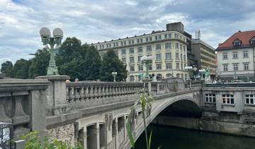 A classic stone bridge over a river with historic buildings in the background.