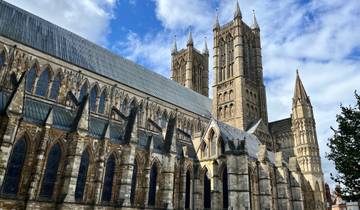 Gothic cathedral with tall towers under a blue sky.