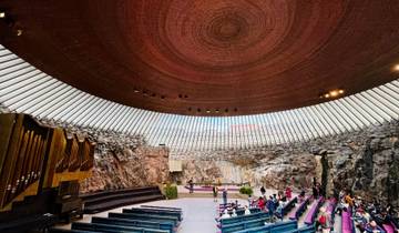 Interior of a modern rock church with visitors.