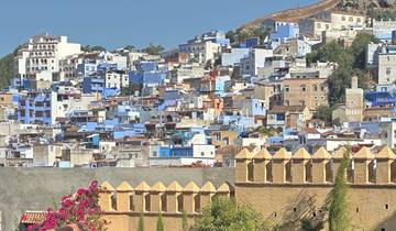 Scenic view of Chefchaouen with blue and white buildings on a hill.