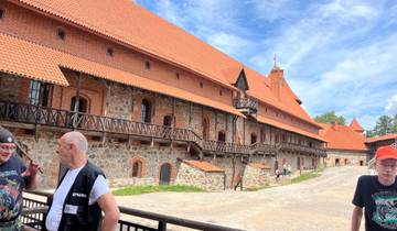 Trakai Castle in Lithuania with visitors nearby.
