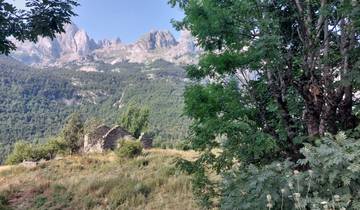 Mountain view with ruins and greenery.