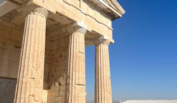 Close-up of ancient columns against a clear blue sky.