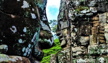 Close-up of ancient temple carvings with faces.