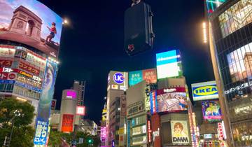 Vibrant cityscape of Shibuya with bright advertisements at night