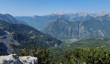 Expansive mountain range with lush valleys.