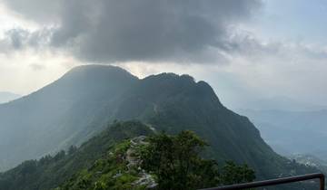 Mountainous landscape under a cloudy sky.