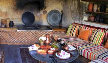 Indoor setup with traditional seating and food served on a low table