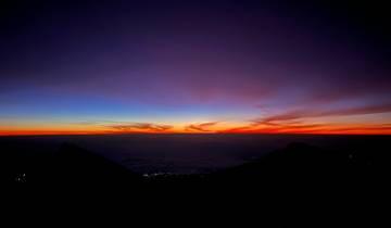 Sunset with a vibrant sky over mountains.