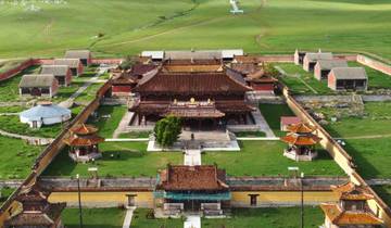 Amarbayasgalant Monastery surrounded by green fields.