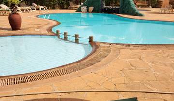 Swimming pool area with sun loungers.