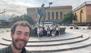 Group posing in front of a fountain with artsy backdrop.