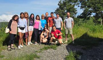 Group of travelers in a lush outdoor setting.