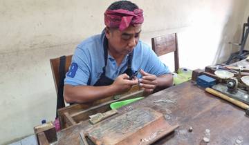 Man working on craftsmanship, concentrating on a piece in his hands.