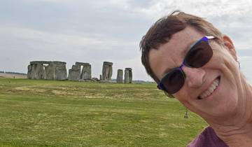 Person taking a selfie with Stonehenge in the background.