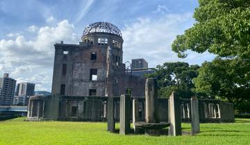 Ruins of the Atomic Bomb Dome in a grassy area.