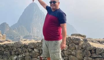 A man standing with Machu Picchu in the background.