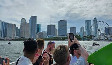 Group of people on a boat with Miami skyline in the background.