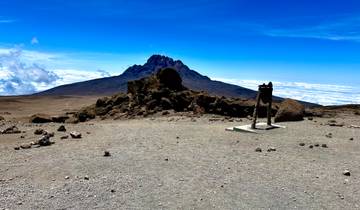 Distant view of a mountain peak against a clear sky.