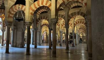 Intricate architecture with striped arches inside a mosque.