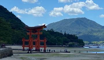 Torii gate with mountains and water in the background.