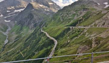 Winding mountain road with lush greenery.