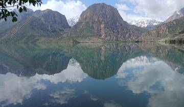 Mountain reflected in a clear lake under a blue sky.