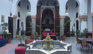 Traditional Moroccan interior courtyard with a fountain.