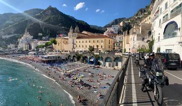 Scenic coastal town with a sandy beach and visitors.