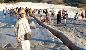 Group of tourists walking on a travertine terrace.