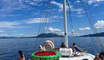 People relaxing on a sailboat in the open sea.