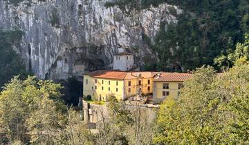 Stone monastery built into a rock face.