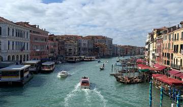 Busy canal with boats and vibrant buildings along the sides.