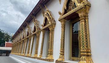 A detailed view of an ornate golden temple facade.