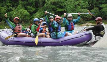 Group of people in a raft enjoying white-water rafting.