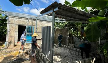 Group of people building a structure outside.
