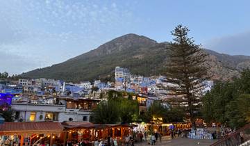 Scenic view of a hillside town with colorful buildings at dusk.