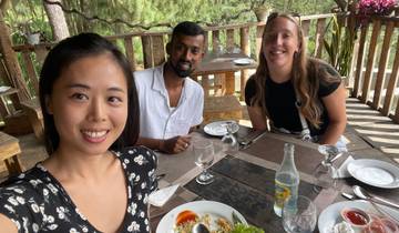 Three people having a meal at a restaurant.