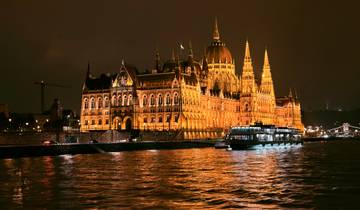 Night view of Budapest Parliament with reflections on the water
