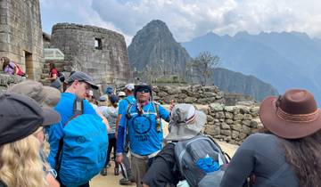 Guide speaking to a group of tourists at Machu Picchu.