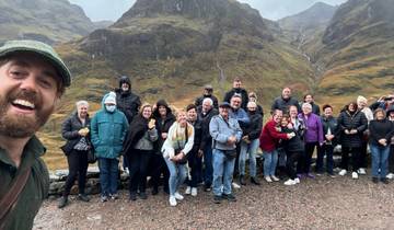 Group posing in front of a mountain landscape.